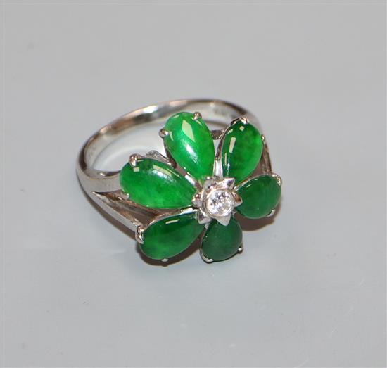 A modern 18k white metal, jadeite and diamond set flowerhead cluster ring, size P.